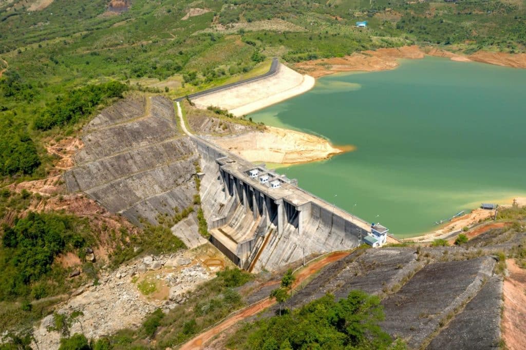 Stunning aerial photo showcasing a massive dam and reservoir surrounded by lush landscapes.