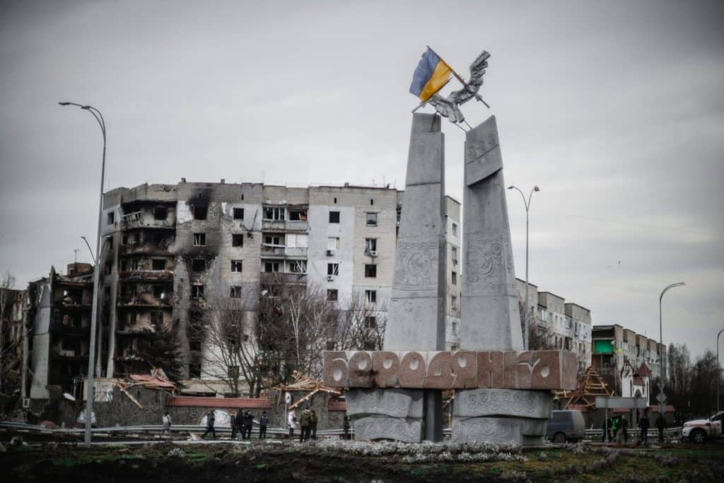 A monument stands beside war-torn buildings in Borodyanka, Ukraine.