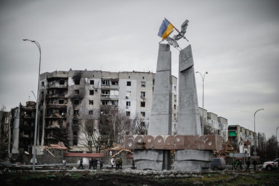 A monument stands beside war-torn buildings in Borodyanka, Ukraine.