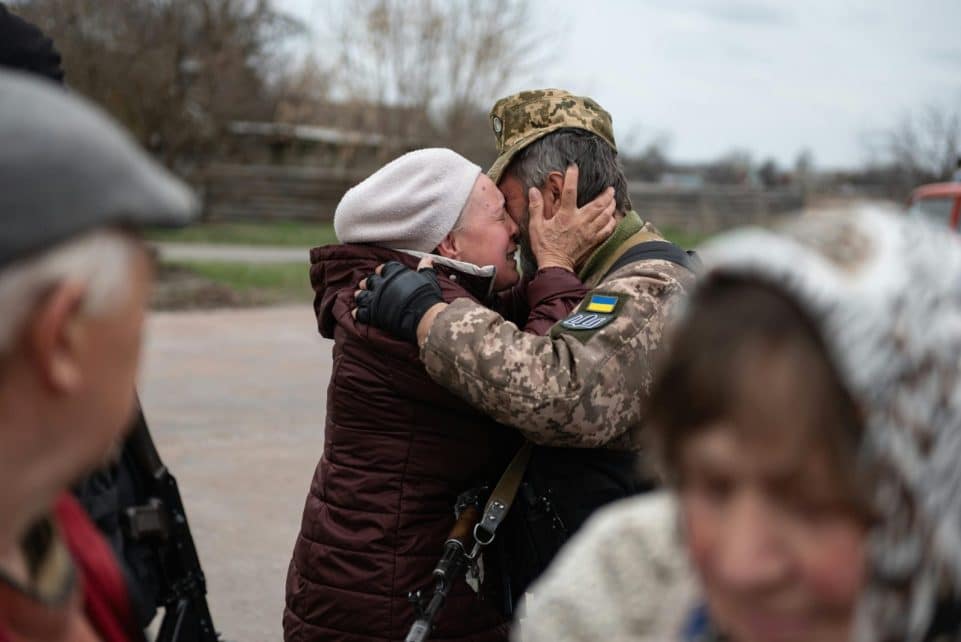 Heartfelt embrace in Makariv, Ukraine, capturing the emotional reunion.