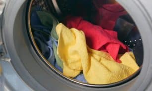 Vibrant close-up of multicolored towels inside a washing machine, ready for a wash.