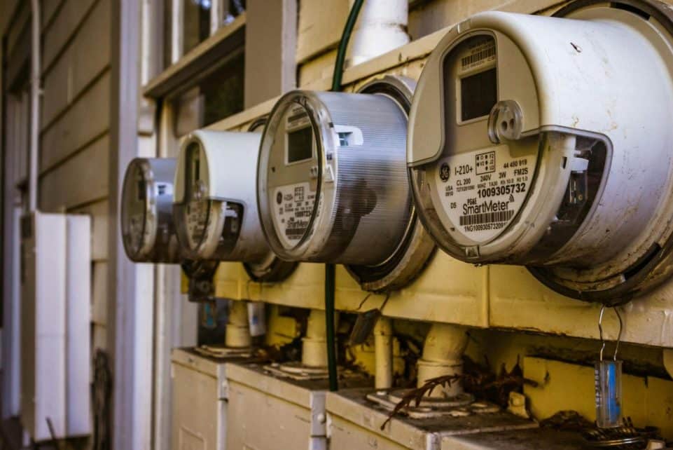 Image of multiple smart electricity meters installed on a residential exterior wall, showing environmental adaptation.