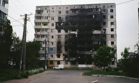 A heavily damaged apartment building in Borodyanka, Ukraine, illustrating urban devastation.