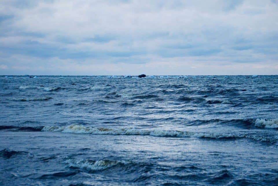 Peaceful seascape of rippling waves at Vääna-Jõesuu, Estonia, under a cloudy sky.