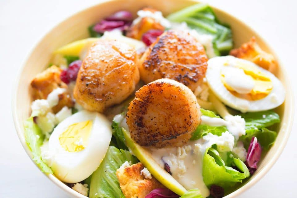 Delicious scallop salad with boiled eggs and fresh greens, perfect for a healthy meal.