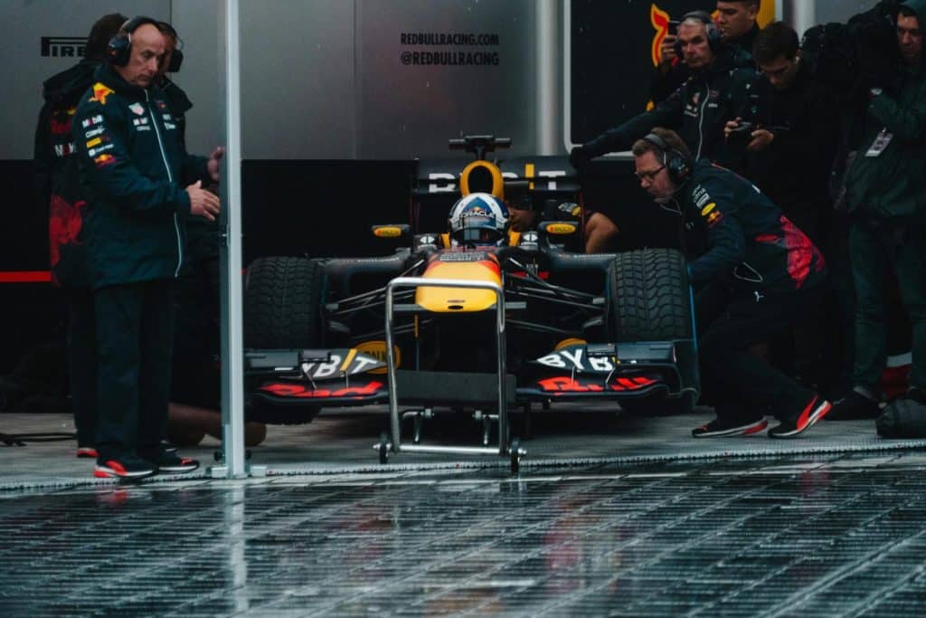 Red Bull Racing pit crew readying the Formula 1 car during an intense race event.