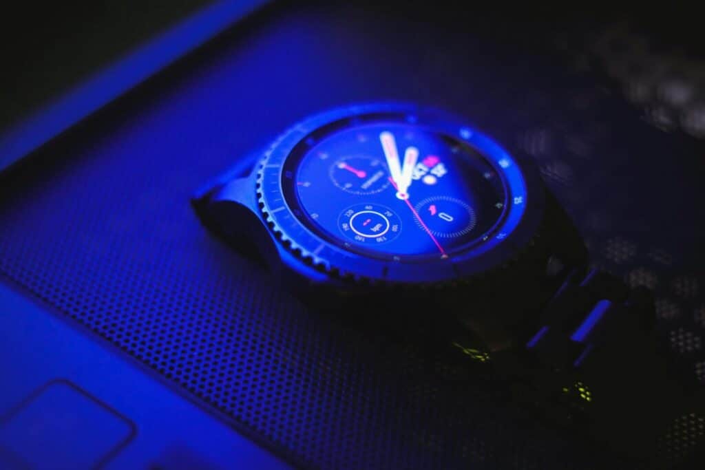 A sleek digital wristwatch illuminated by blue light, showcasing time with precision.
