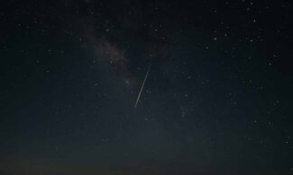 Beautiful night sky showcasing a shooting star against the Milky Way galaxy.