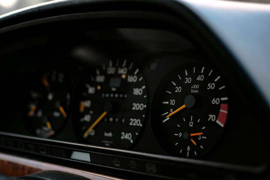 Detailed image of a classic car dashboard showing speedometer and tachometer readings.