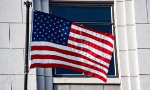 US flag on a building, symbolizing patriotism and freedom.