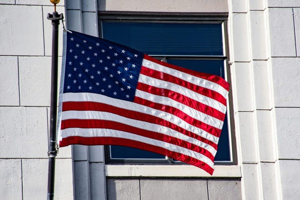 US flag on a building, symbolizing patriotism and freedom.