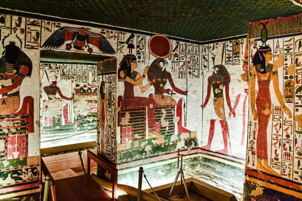 Colorful murals inside an Egyptian tomb in Luxor, showcasing historical art.
