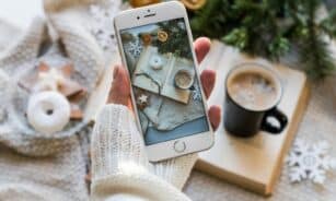 Top view of cozy winter setting with coffee, smartphone capturing a warm flat lay.