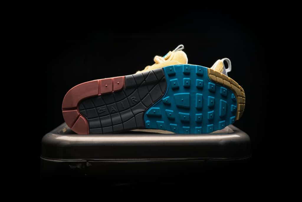 Detailed shot of a colorful sneaker sole on a black background, showcasing vibrant design.