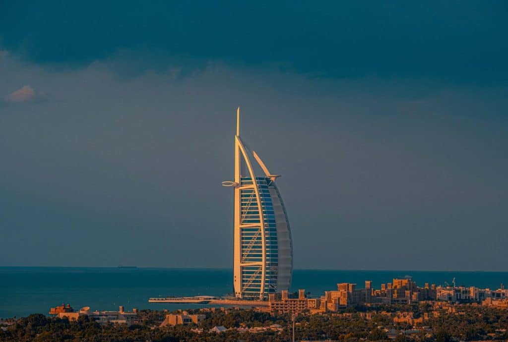 Gorgeous sunset view of the iconic Burj Al Arab hotel in Dubai against the sea.