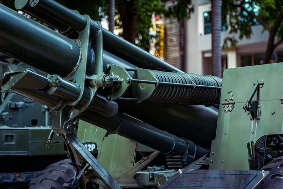 Detailed view of military artillery equipment displayed outdoors in a museum setting.