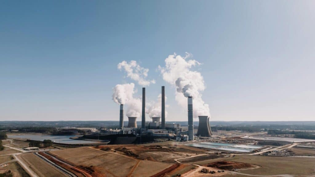 Aerial view of a power plant emitting smoke with clear blue sky in Euharlee, Georgia.