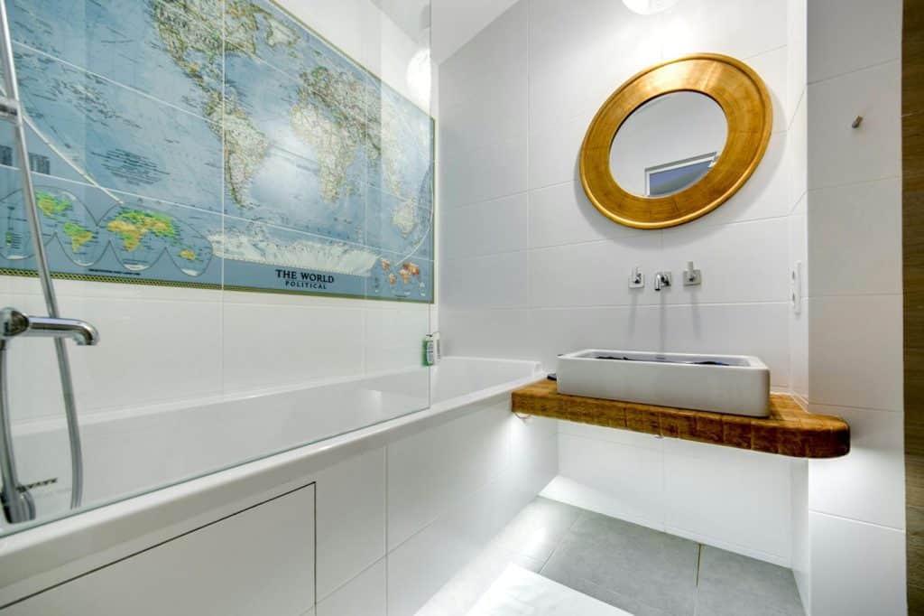 Elegant bathroom featuring a modern design with a world map decor and circular mirror.