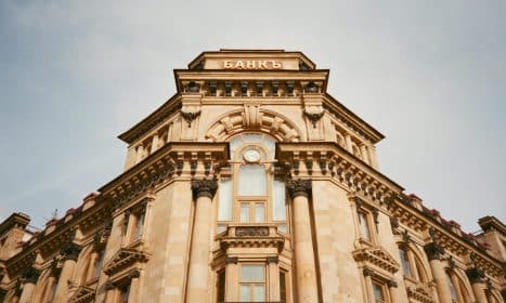 Ornate bank facade in Moscow featuring columns, windows, and architectural details.