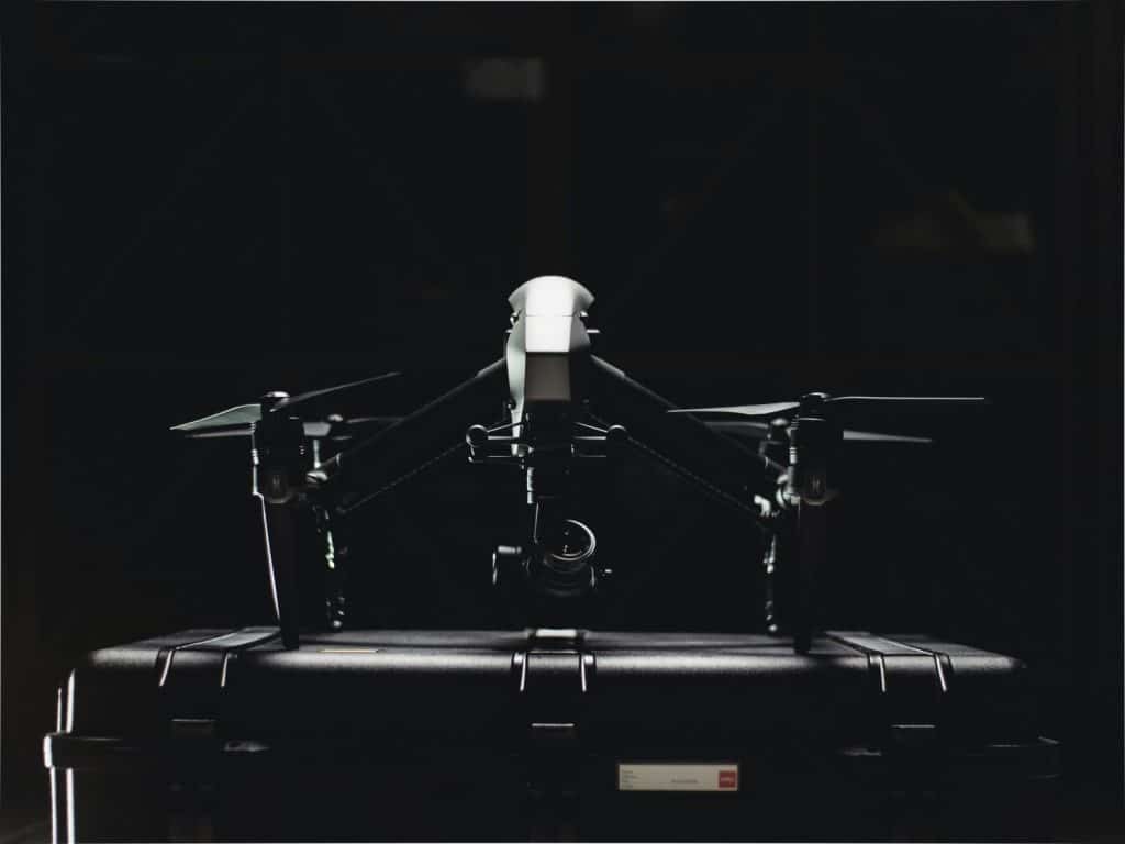 Close-up of a professional drone and its storage case, showcasing sleek design.