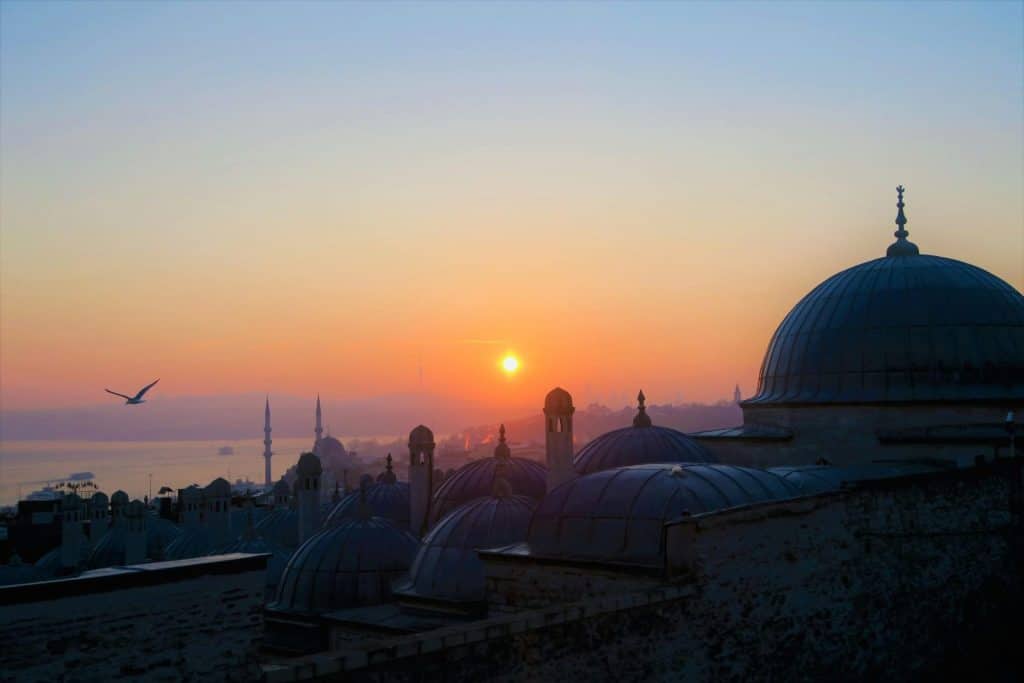 Beautiful view of Istanbul's mosques at sunset with vibrant sky and silhouettes.