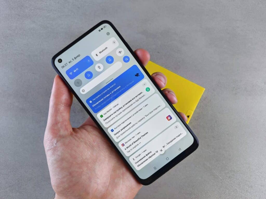 A close-up of a hand holding a smartphone displaying multiple notifications, highlighting modern technology.