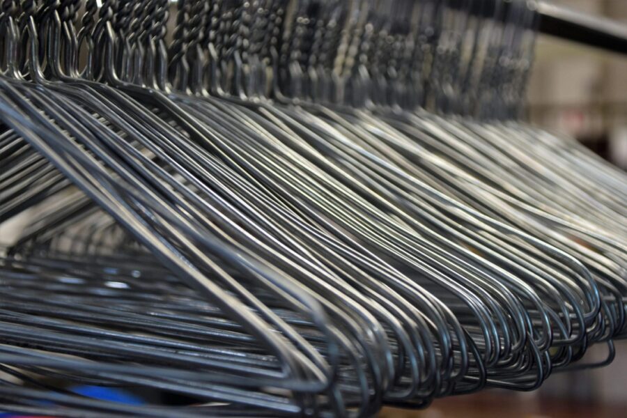 Close-up of metal clothes hangers organized in a closet, highlighting the simplicity and utility of storage solutions.