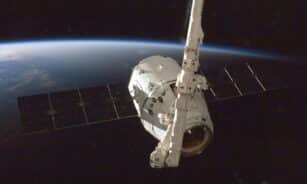 A satellite orbiting Earth with a view of the planet from space.