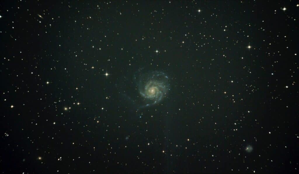 Deep space image featuring the mesmerizing Pinwheel Galaxy surrounded by stars.