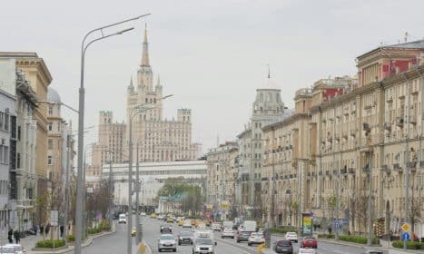 View of Moscow cityscape with Kudrinskaya Square Building, highlighting urban architecture and traffic.