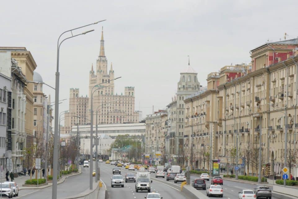 View of Moscow cityscape with Kudrinskaya Square Building, highlighting urban architecture and traffic.