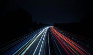 Long exposure photo of vibrant light trails on a highway at night in Osnabrück, Germany.