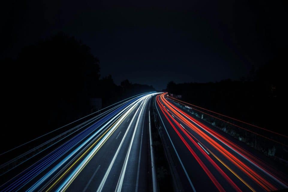 Long exposure photo of vibrant light trails on a highway at night in Osnabrück, Germany.