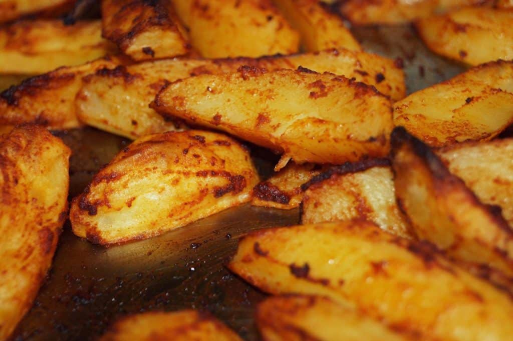Close-up of homemade roasted potatoes with a golden crispy finish. Perfect for a delicious meal.