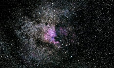 Captivating image of a vibrant nebula filled with stars in the expansive universe.