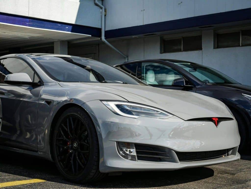 Close-up view of a sleek Tesla Model S parked outdoors, showcasing modern electric vehicle design.