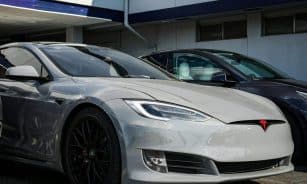 Close-up view of a sleek Tesla Model S parked outdoors, showcasing modern electric vehicle design.