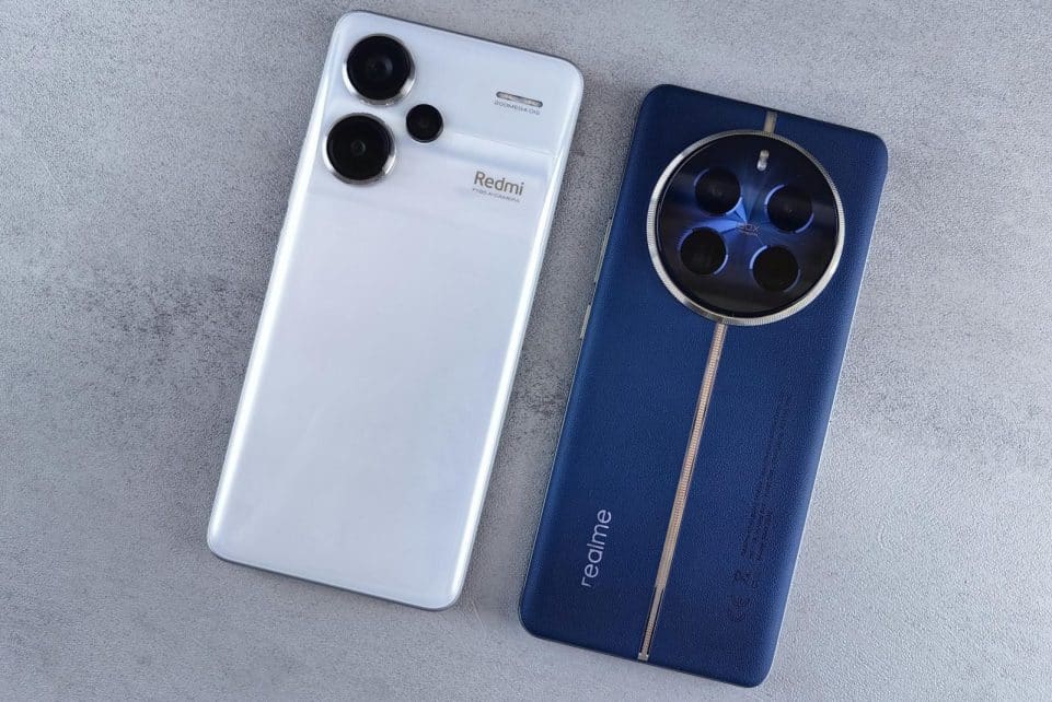 Two smartphones, one white and one blue, displayed on a textured grey background.