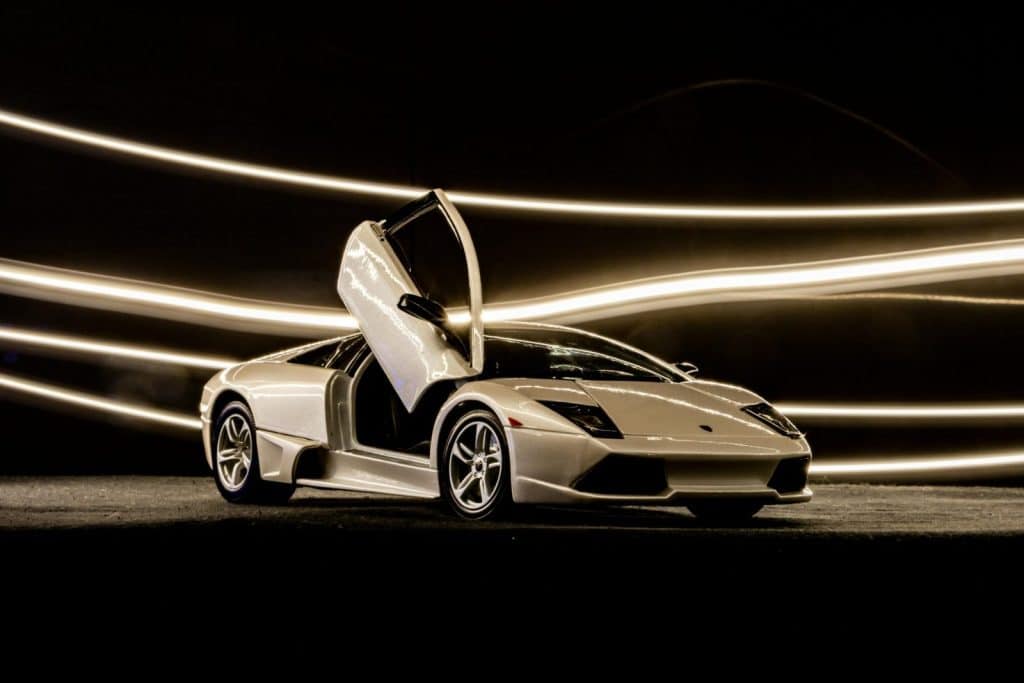 Stunning white Lamborghini Murcielago with scissor doors open, showcasing elegance and power.