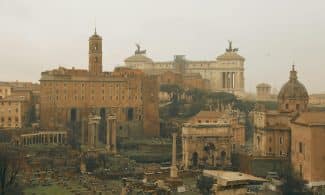 Panoramic view of ancient Roman ruins and historic architecture in Rome, Italy.