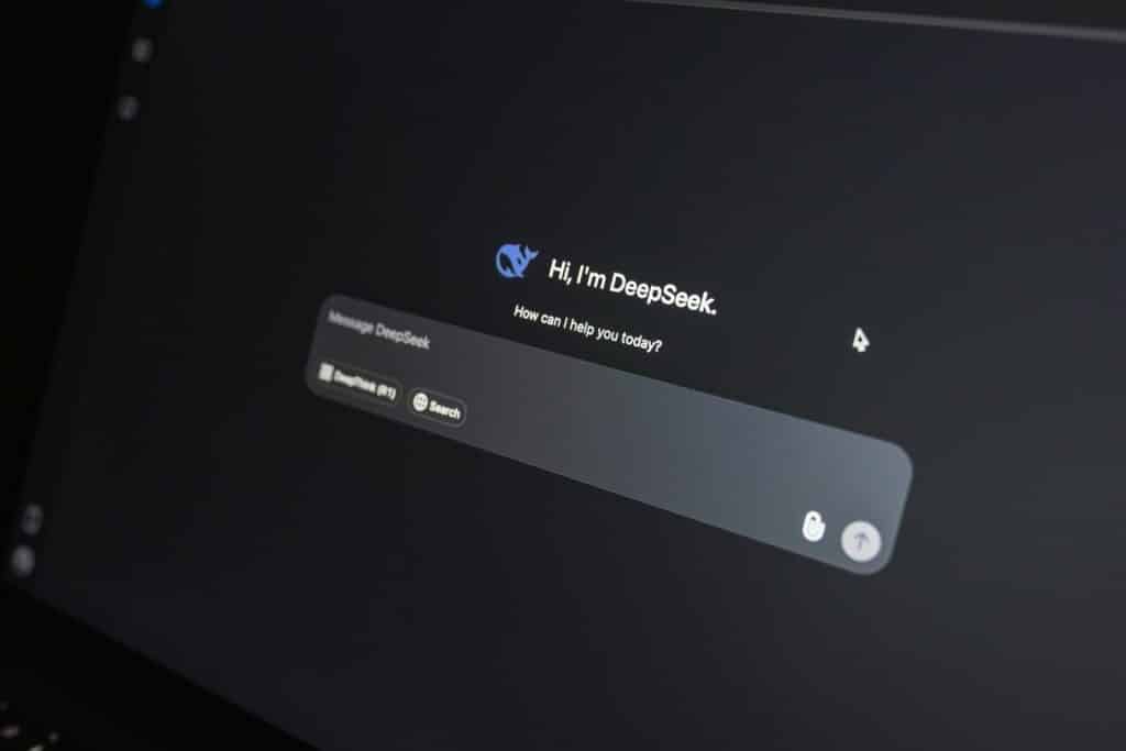 Close-up of DeepSeek AI chat interface on a laptop screen in low light.