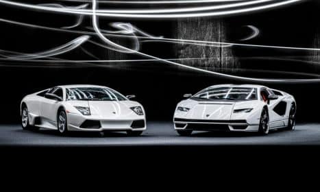 Elegant white Lamborghini Murcielago and Countach showcased with dynamic studio lighting.