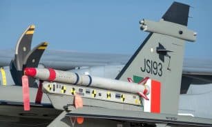 Aircraft tail with missile at Aero India in Bengaluru. Detailed close-up for aviation enthusiasts.