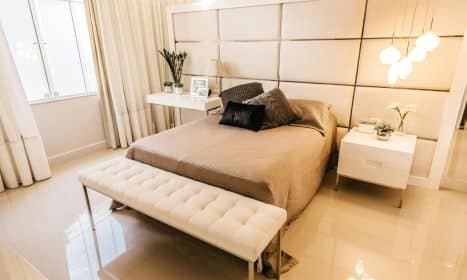 Luxurious modern bedroom featuring elegant design elements, soft lighting, and cozy bedding.