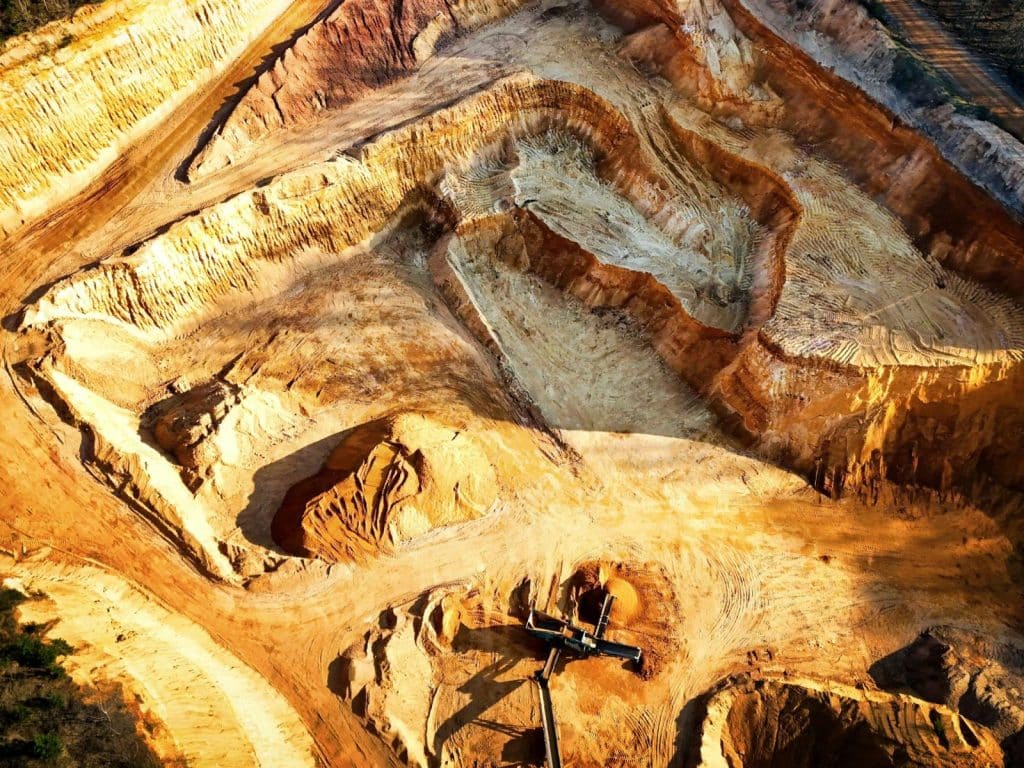 A striking aerial view of a large open-pit mine showcasing its excavation patterns.