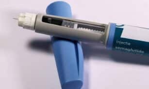 Detailed view of a semaglutide injection pen, commonly used for diabetes treatment, on a plain background.