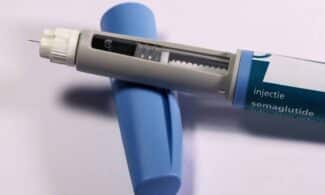 Detailed view of a semaglutide injection pen, commonly used for diabetes treatment, on a plain background.