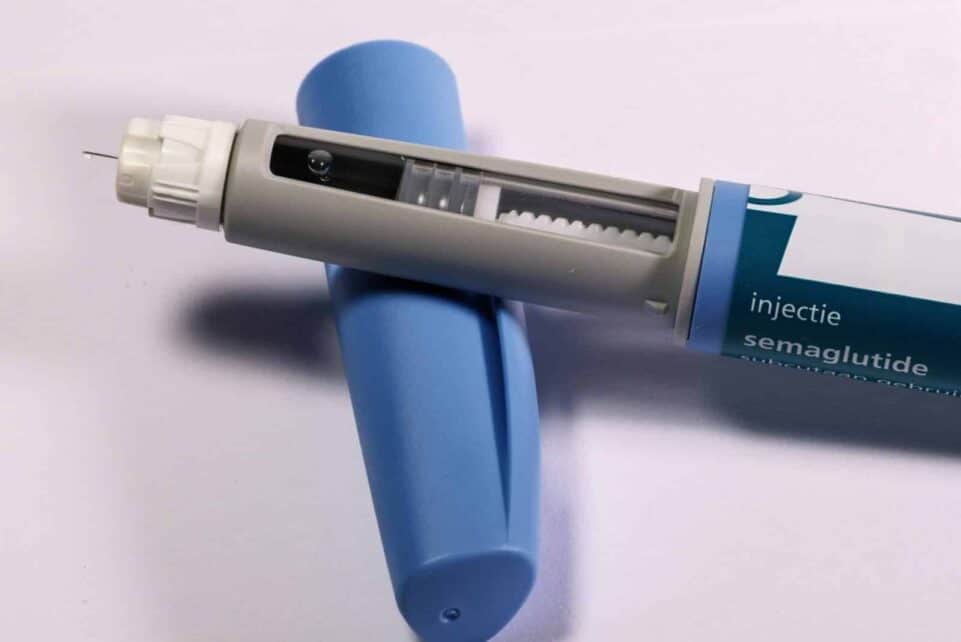 Detailed view of a semaglutide injection pen, commonly used for diabetes treatment, on a plain background.