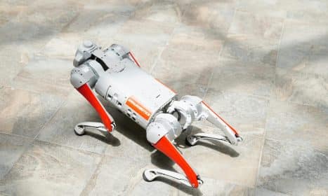 High-tech robotic dog on a tiled surface, showcasing cutting-edge robotics.