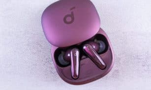 Modern purple earbuds resting in an open case, featuring glossy finish and sleek design.